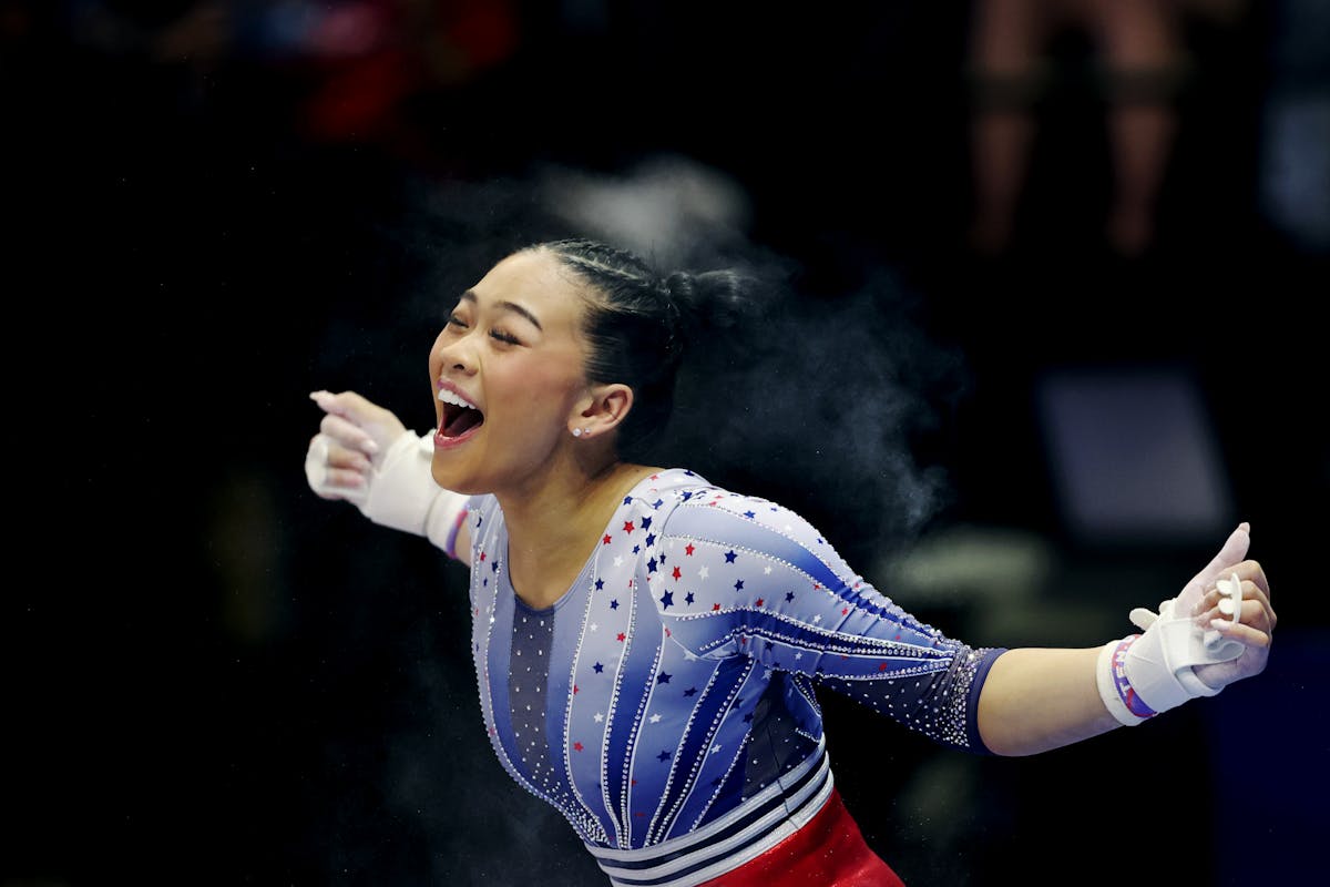 Suni Lee of St. Paul cheers after the dismount of the highest-scoring uneven bars performance across both nights of the U.S. Olympic women's gymnastic