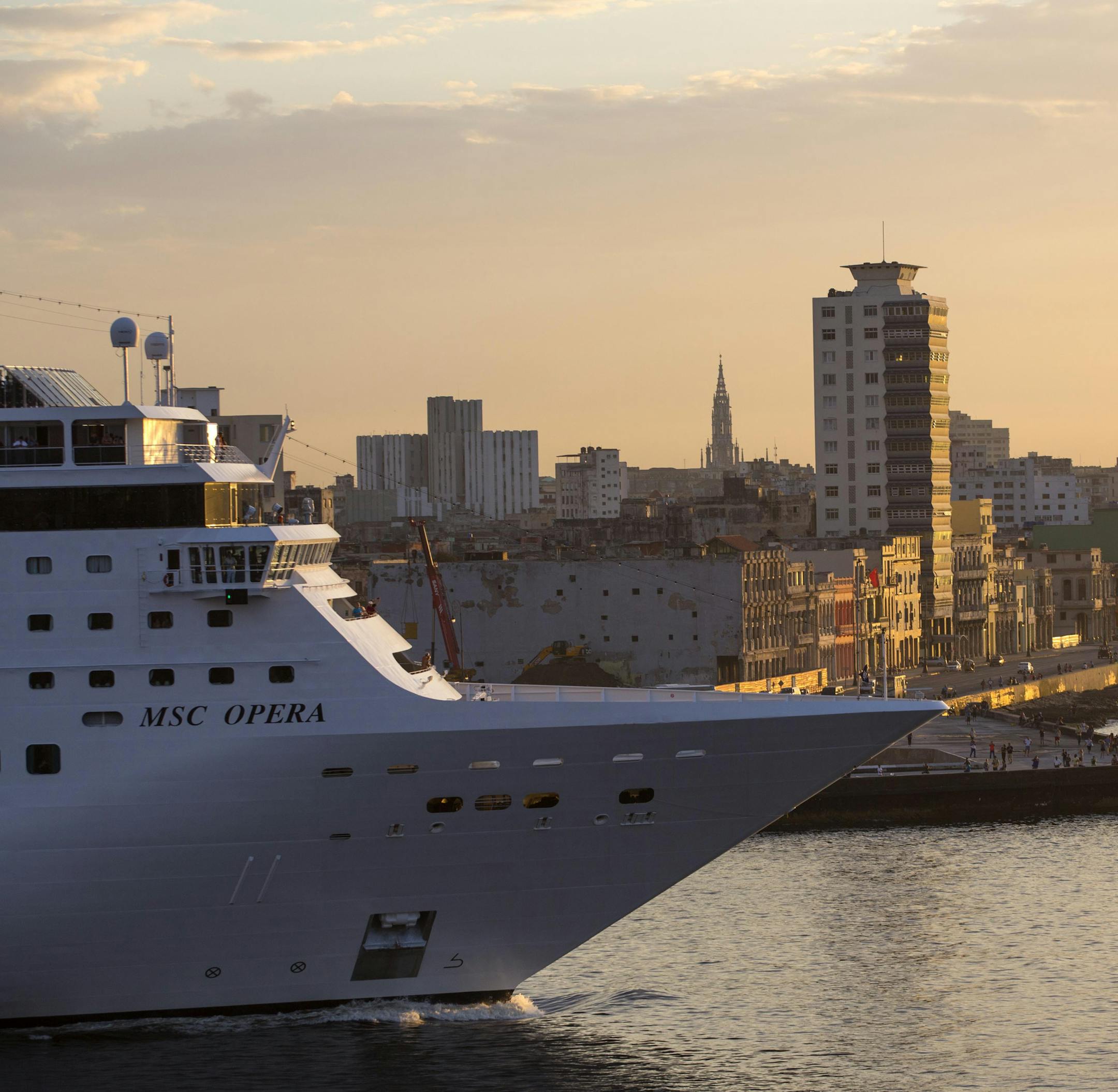 In this Feb. 4 2016 photo the MSC Opera cruise ship passes the Malecon sea wall as it leaves the harbor in Havana, Cuba. (AP Photo/Desmond Boylan)