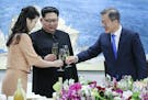 South Korean President Moon Jae-in, right, toasts with Ri Sol Ju, wife of North Korean leader Kim Jong Un during a banquet at the border village of Pa