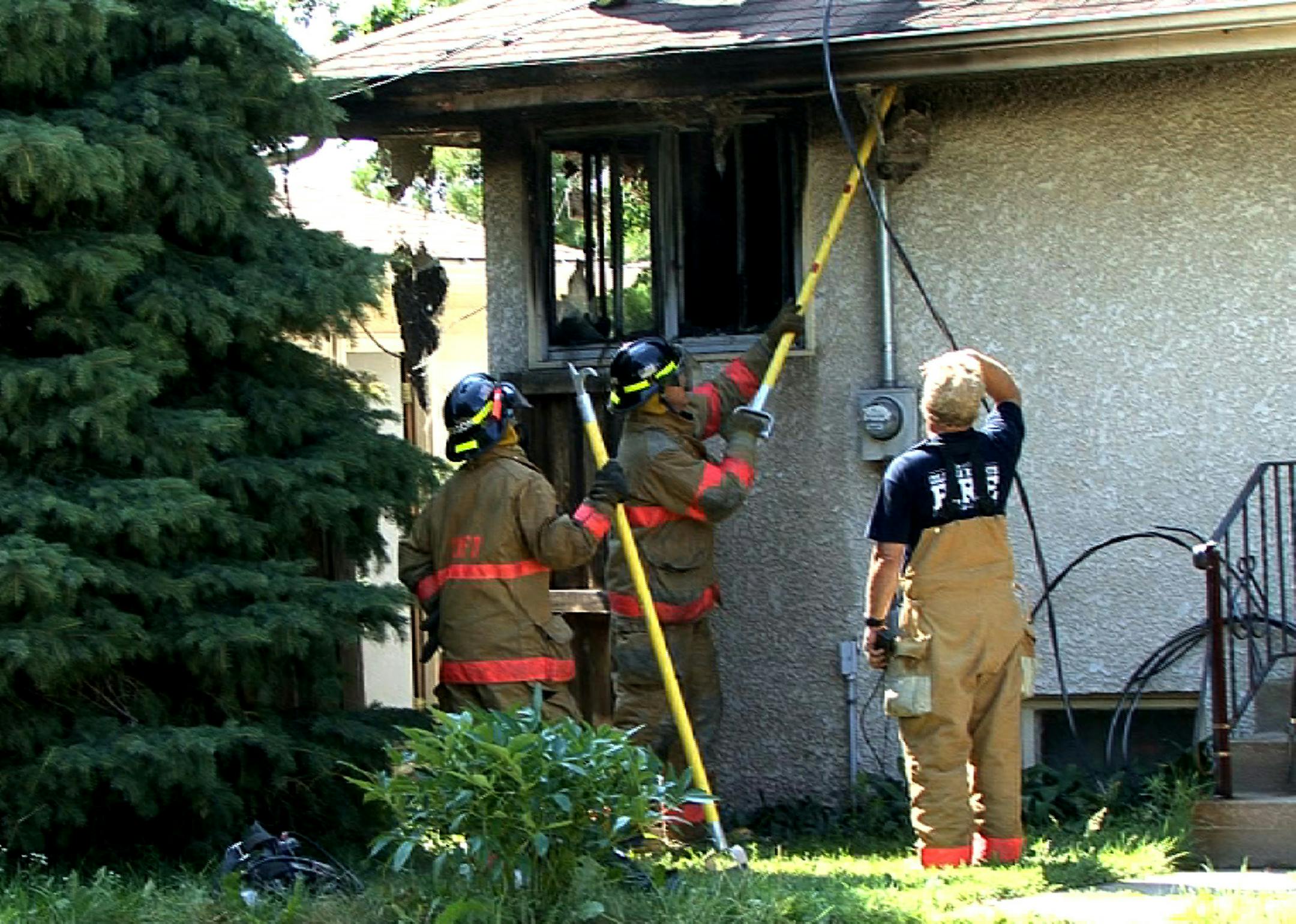 Firefighters worked on a Columbia Heights home where Sherrill Harnden was believed stabbed to death by her husband, who then set their house on fire Friday morning.