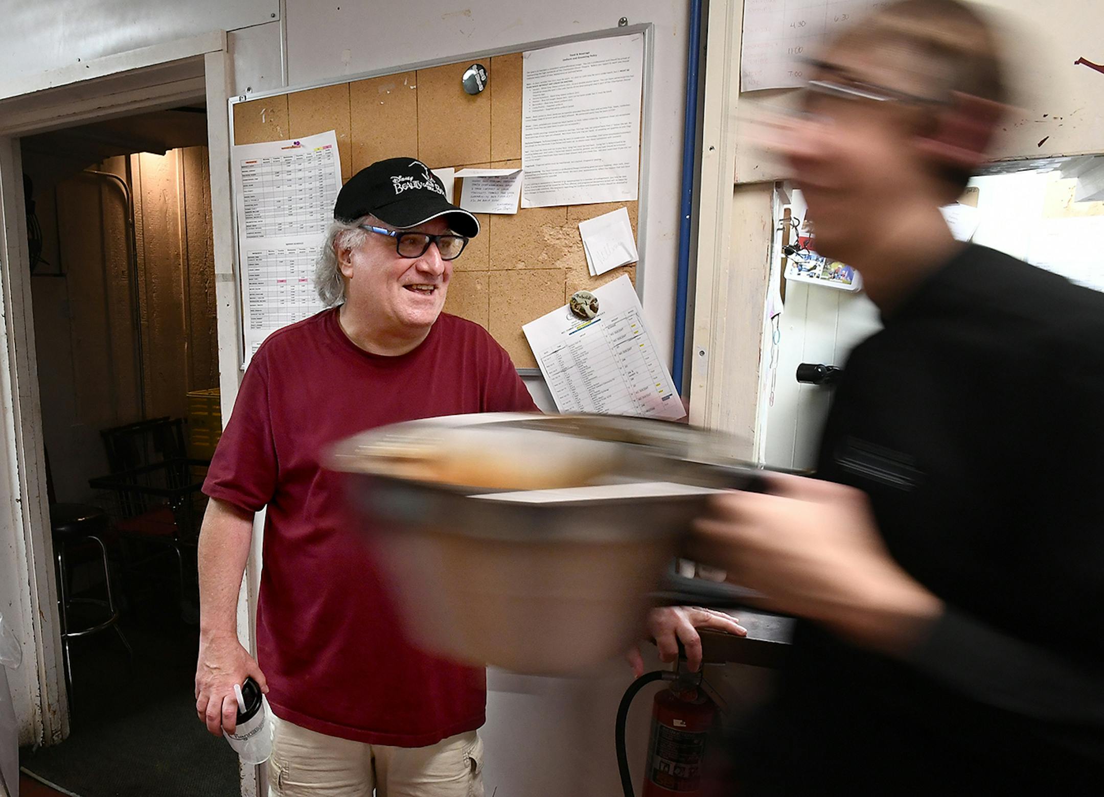 Chanhassen Dinner Theatres owner Michael Brindisi, center, watched as employees worked in the kitchen during a performance of "Beauty and the Beast" Friday night.