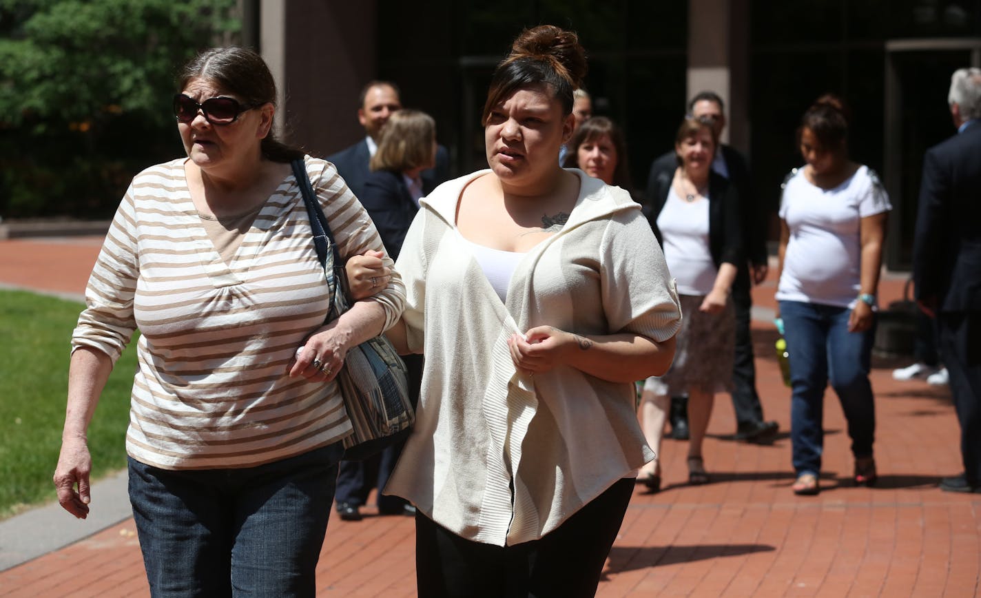 Debbie Erickson, mother of Dustin Baity, left, and Shante Baity, sister in-law, walked arm in arm to the press conference. ] (KYNDELL HARKNESS/STAR TRIBUNE) kyndell.harkness@startribune.com Hennepin County attorney's office to announce charges in cold case involving double homicide, of Carrie Ritcher and Dustin Baity in Minneapolis at the south end of the Hennepin County Government Center in Minneapolis, Min. Wednesday, July 9, 2014.