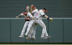 Minnesota Twins outfielders Eddie Rosario, from left, Byron Buxton and Max Kepler celebrate after a baseball game against the Baltimore Orioles in Bal