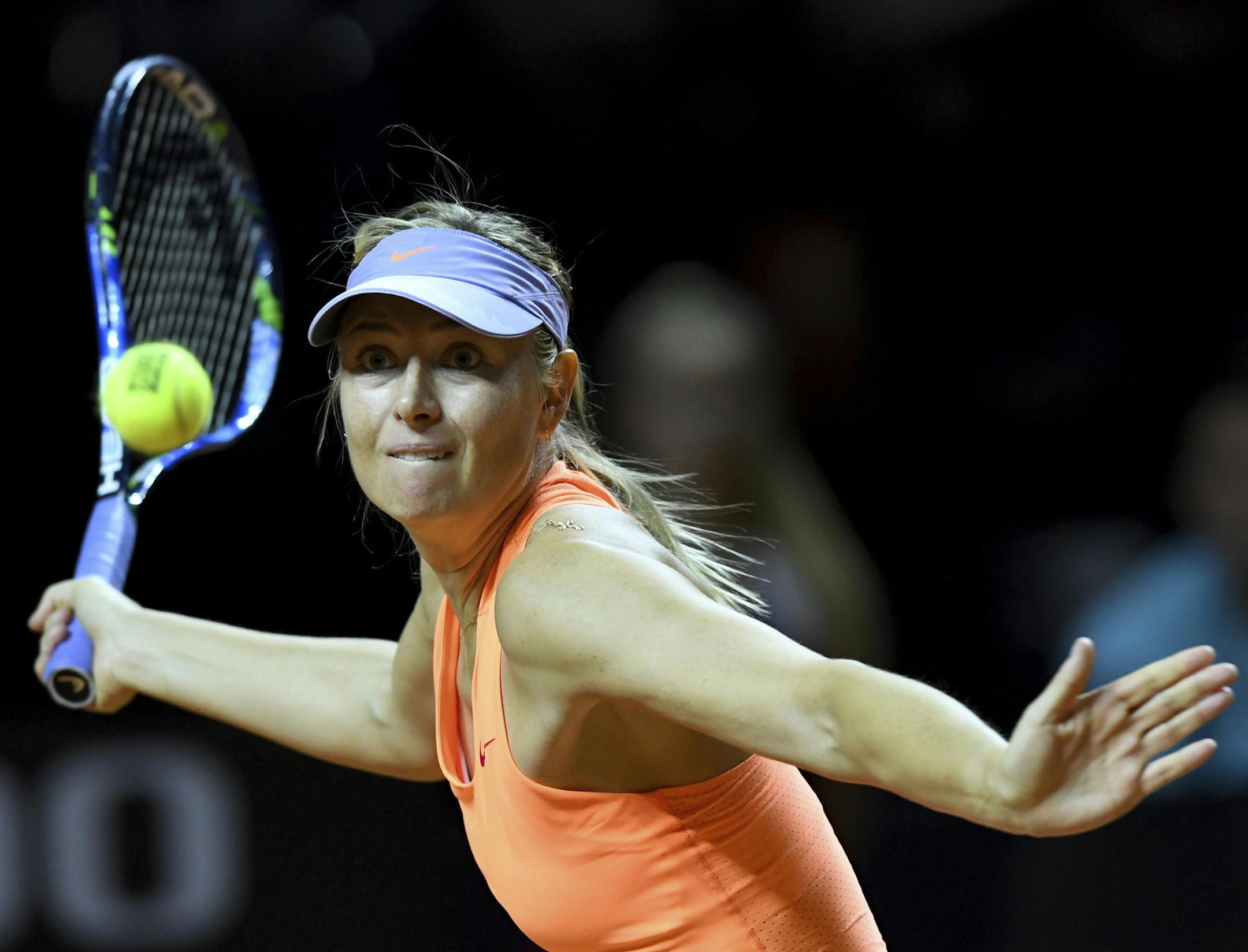 Russian tennis player Maria Sharapova returns the ball to Kristina Mladenovic from France during the Porsche Tennis Grand Prix in Stuttgart, Germany, Saturday, April 29, 2017. (Bernd Weissbrod/dpa via AP)