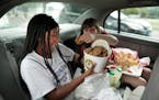 Nevaeh McCave, 12 and Laila Morneau were all smiles after getting a bucket of Sweet Martha Cookies on their final food stop Thursday morning at the fa
