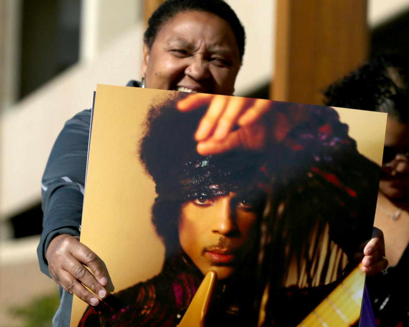 Gwen Guess of Plymouth holds one of the Prince posters she bought during the first Paisley Park Tour Thursday, Oct. 6, 2016, in Chanhassen, MN.