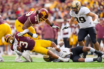 Gophers running back Trey Potts (3) was tackled by Purdue cornerback Bryce Hampton in the first quarter Saturday at Huntington Bank Stadium.