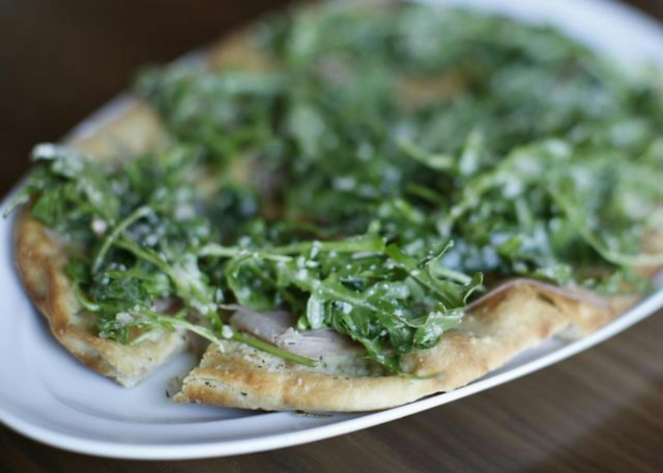 Flatbread with prosciutto, arugula and Parmesan cheese.