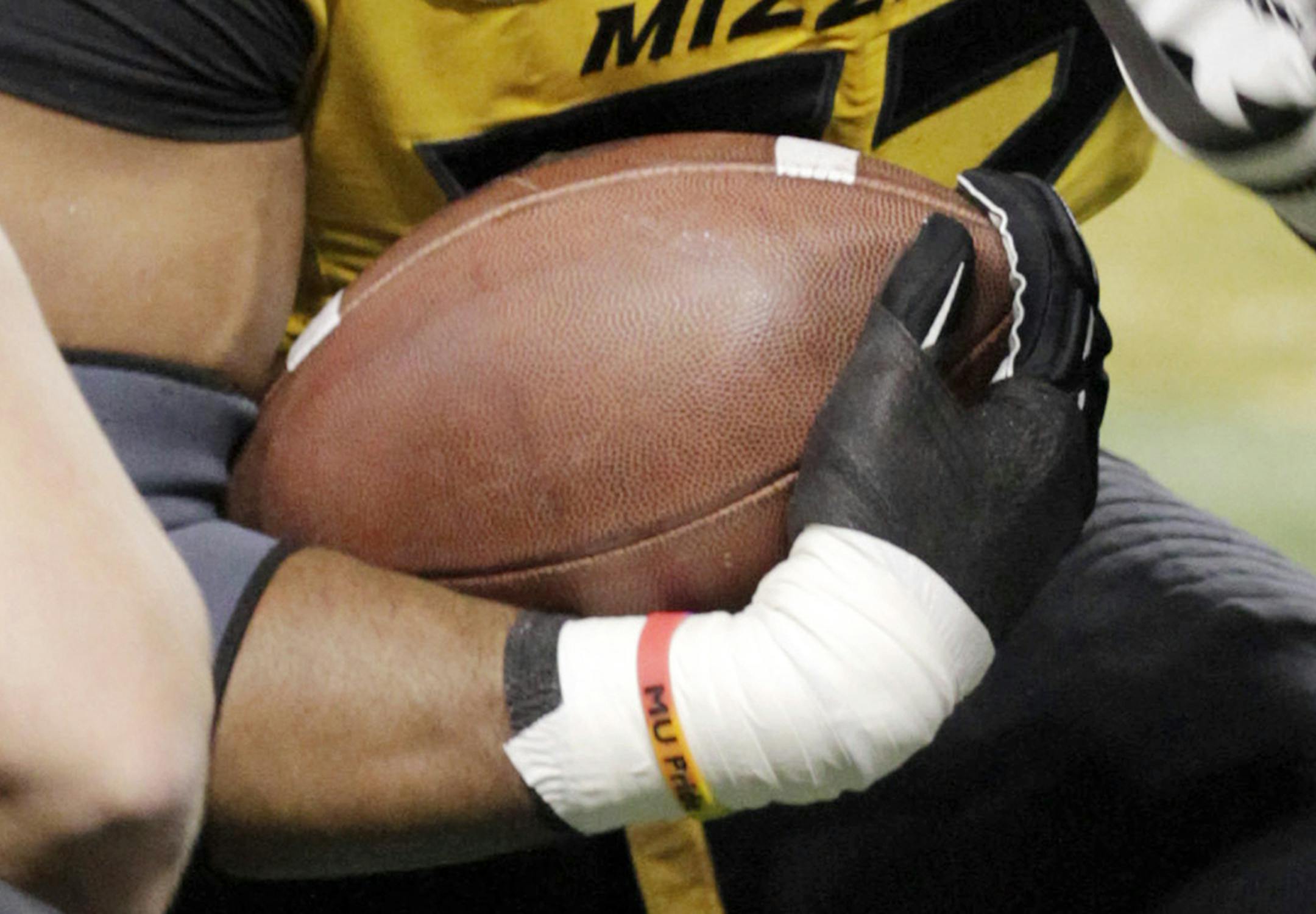 In this Jan. 3, 2014 photo, Missouri defensive lineman Michael Sam wore an "MU Pride" bracelet made by Triangle Coalition, a student organization for lesbian, gay, bisexual and transgender people, before the Cotton Bowl against Oklahoma State. Missouri's All-America defensive end came out to the entire country Sunday night and could become the first openly gay player in America's most popular sport.