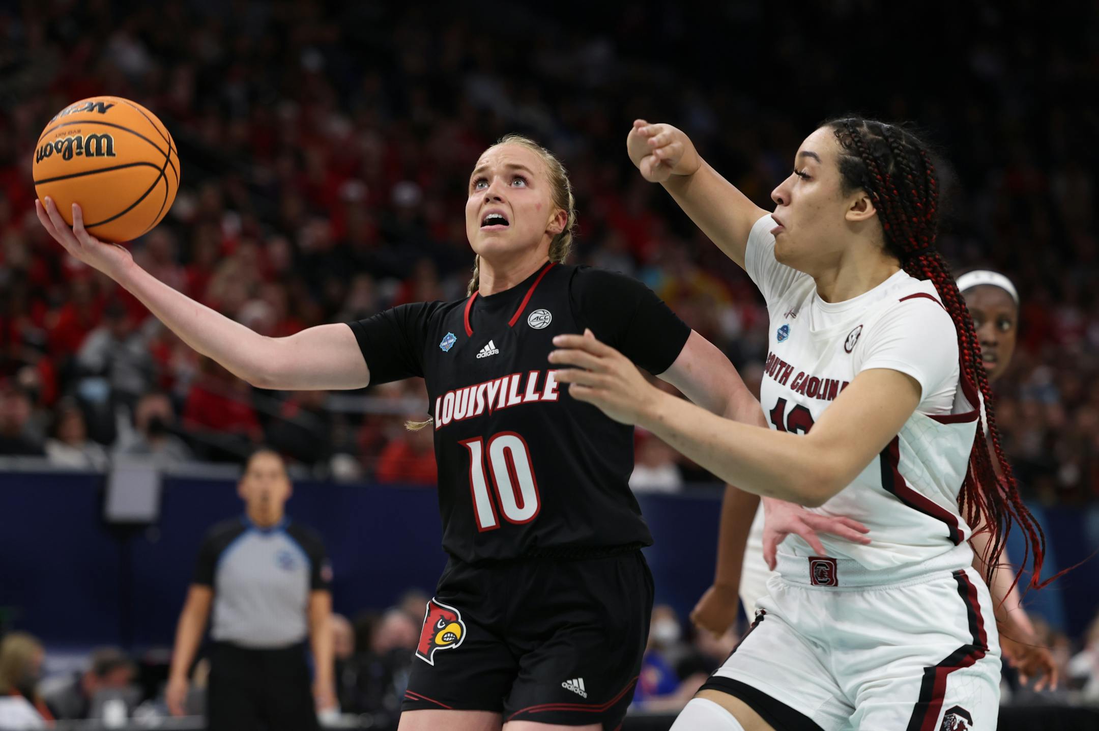 Louisville guard Hailey Van Lith, left, drives past South Carolina guard Brea Beal.