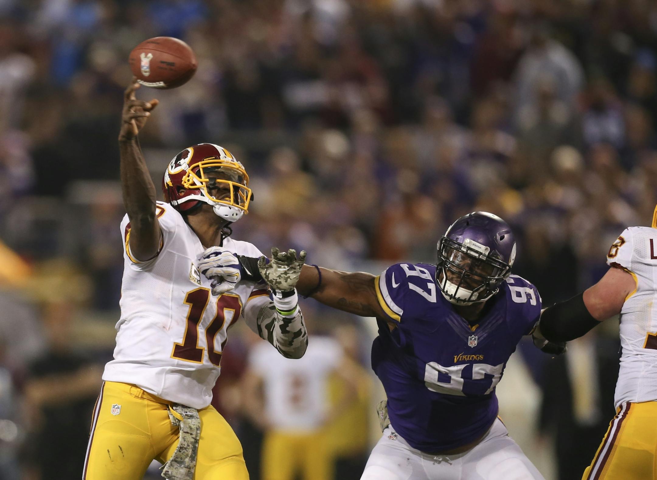 The MInnesota Vikings beat the Washington Redskins 34-27 in an NFL game Thursday night, November 7, 2013 at Mall of America Field in Minneapolis. Minnesota Vikings defensive end Everson Griffen (97) got a hand on Washington Redskins quarterback Robert Griffin III (10) as he released a fourth quarter pass.