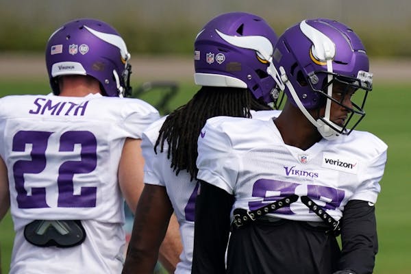 Minnesota Vikings safety Steven Parker (37), right, stretched with his teammates during practice Friday.