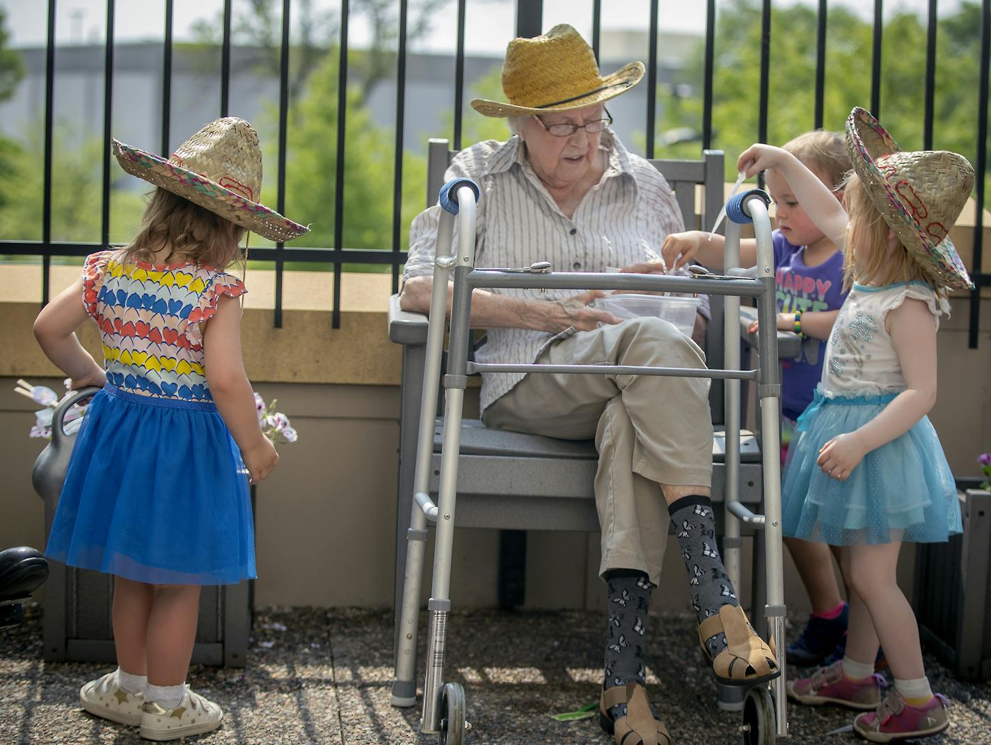 Children from the TowerLight Child Care Center helped Joan Johnson, from the TowerLight Memory Care Unit, water plants as part of their multigenerational program, Friday, May 31, 2019. A growing number of Twin Cities facilities now offer this, part of a growing movement to promote intergenerational diversity, decrease isolation and loneliness among seniors, and meet the demands for quality youth programming and creative older adult programs. ] ELIZABETH FLORES &#x2022; liz.flores@startribune.com