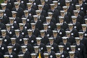 FILE - In this Dec. 14, 2019 file photo, Navy midshipmen march onto field ahead of an NCAA college football game between the Army and the Navy in Phil