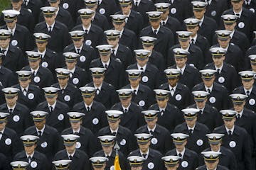 FILE - In this Dec. 14, 2019 file photo, Navy midshipmen march onto field ahead of an NCAA college football game between the Army and the Navy in Phil