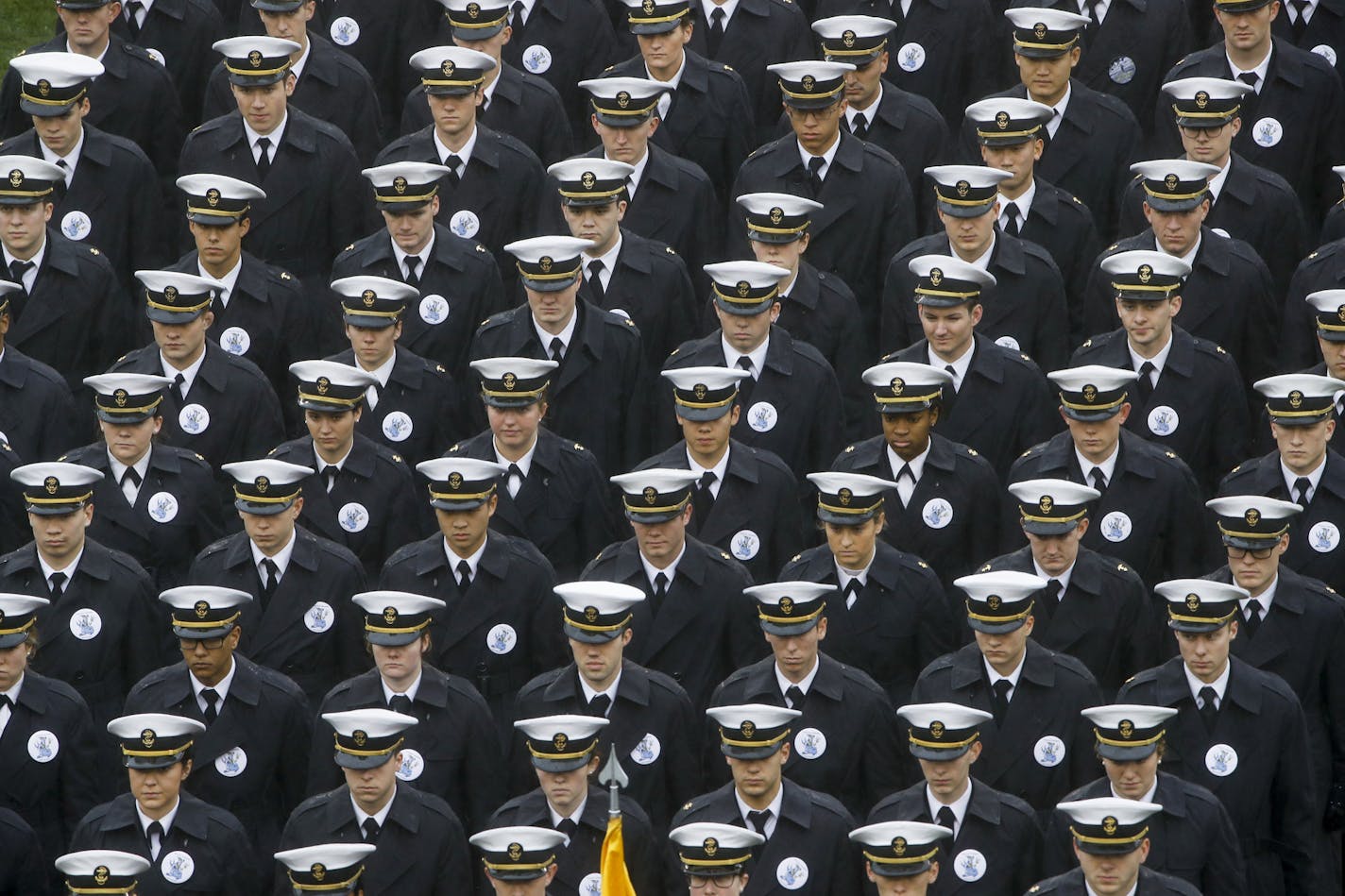 FILE - In this Dec. 14, 2019 file photo, Navy midshipmen march onto field ahead of an NCAA college football game between the Army and the Navy in Philadelphia. A military investigation finds that hand gestures used by cadets and midshipmen during the Army-Navy game broadcast had nothing to do with white supremacy. The investigation, which included interviews and background checks, determined that two freshmen were taking part in a &#x201c;sophomoric&#x201d; game that had &#x201c;no racist intent