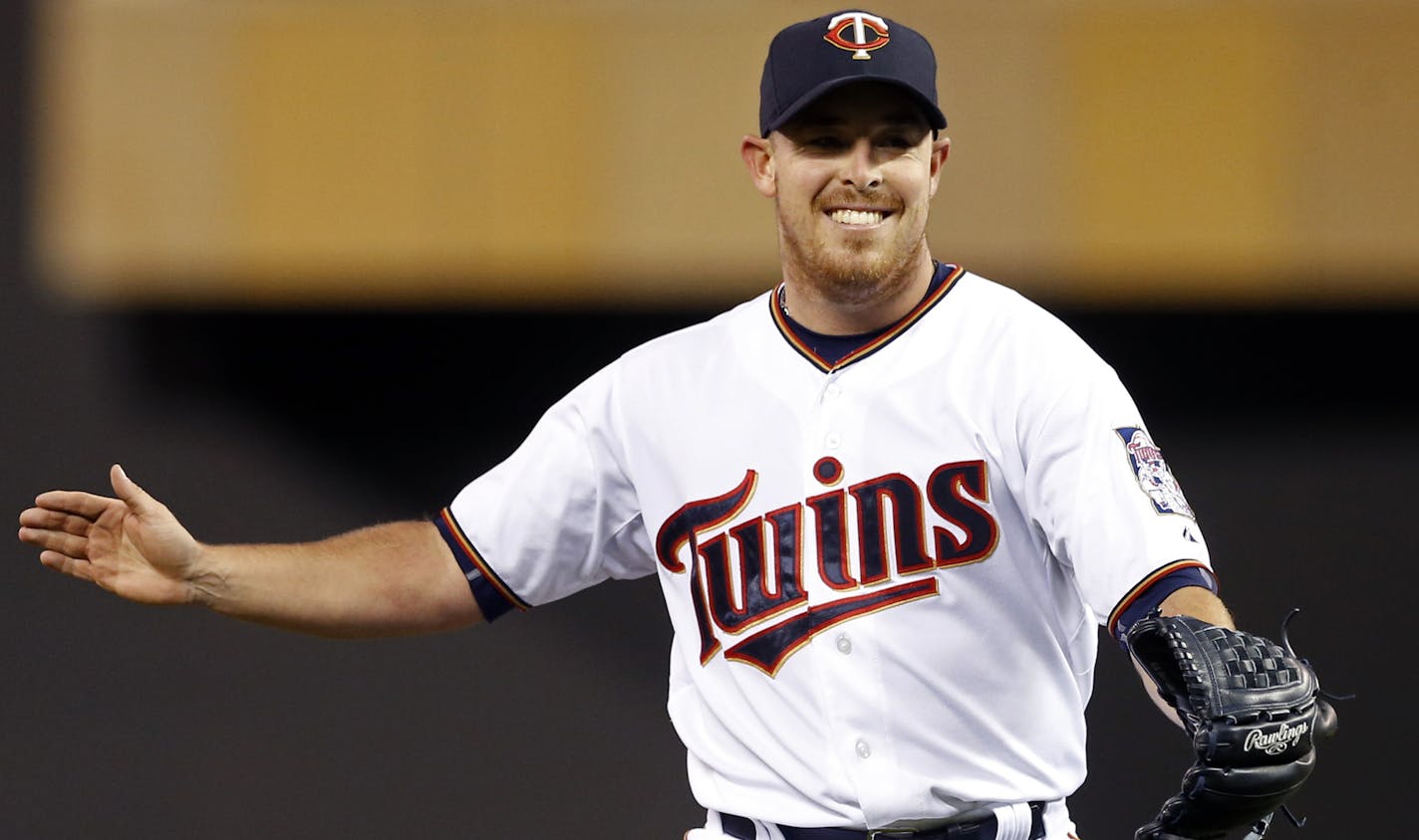 Minnesota Twins starting pitcher J.R. Graham celebrates after the final out as the Twins beat the Chicago White Sox 12-2 in a baseball game, Thursday, April 30, 2015, in Minneapolis. The Twins won 12-2. (AP Photo/Jim Mone) ORG XMIT: MIN2015051114544035