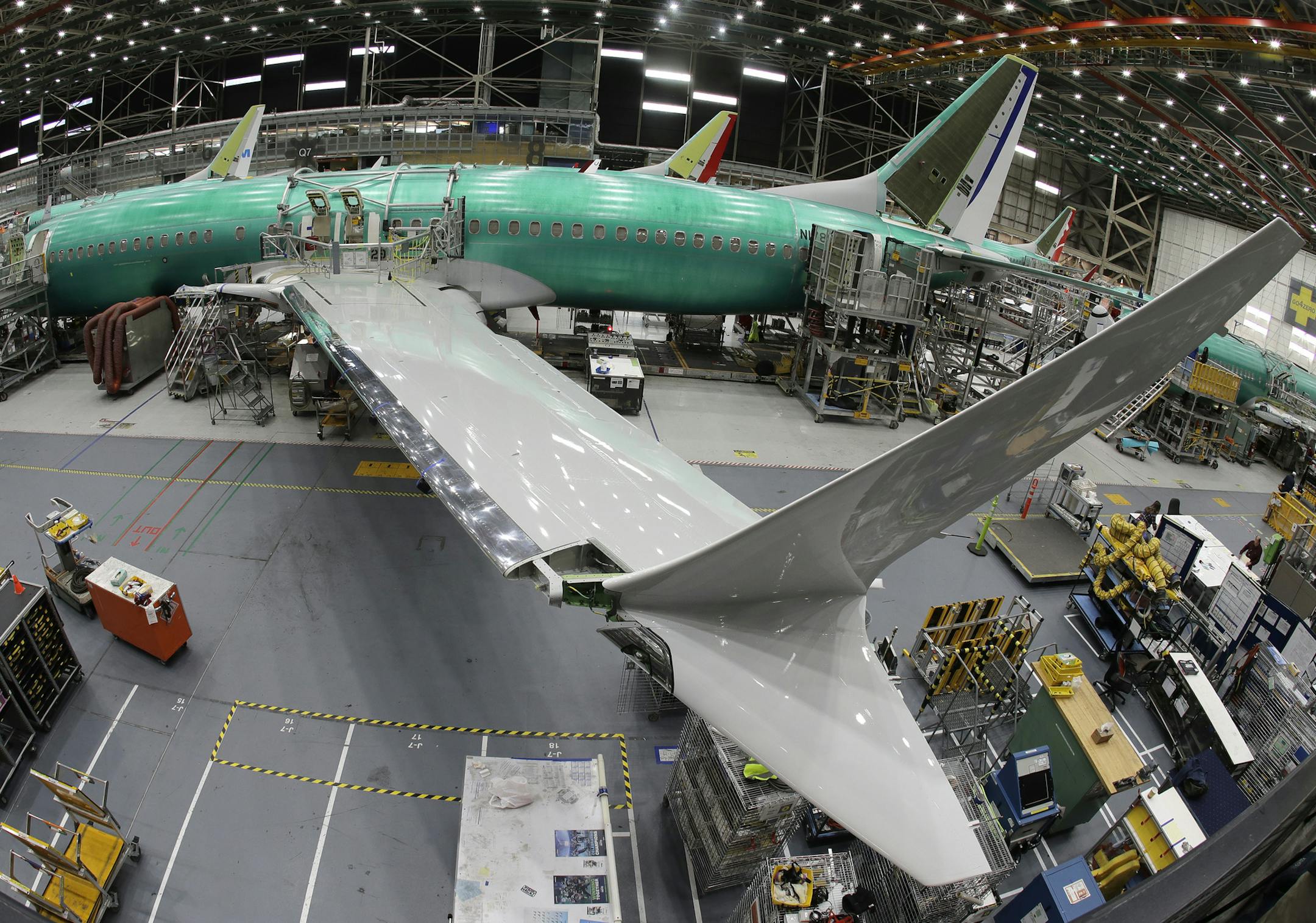 In this photo taken with a fish-eye lens, a Boeing 737 MAX 8 airplane sits on the assembly line during a brief media tour in Boeing's 737 assembly facility, Wednesday, March 27, 2019, in Renton, Wash. The Federal Aviation Administration plans to revamp oversight of airplane development after the two deadly crashes of Boeing's new 737 Max 8 airplane, according to testimony prepared for a Capitol Hill hearing on Wednesday. (AP Photo/Ted S. Warren) ORG XMIT: WATW106