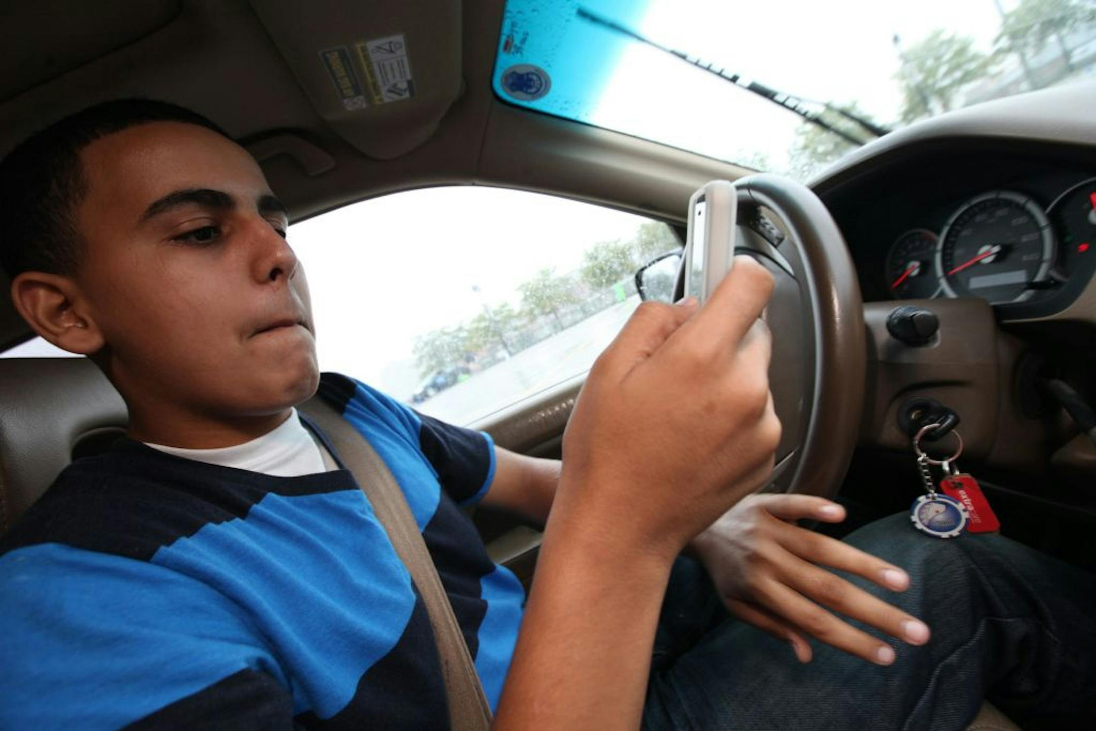 A teen getting a lesson in texting and driving during a safe driving course.
