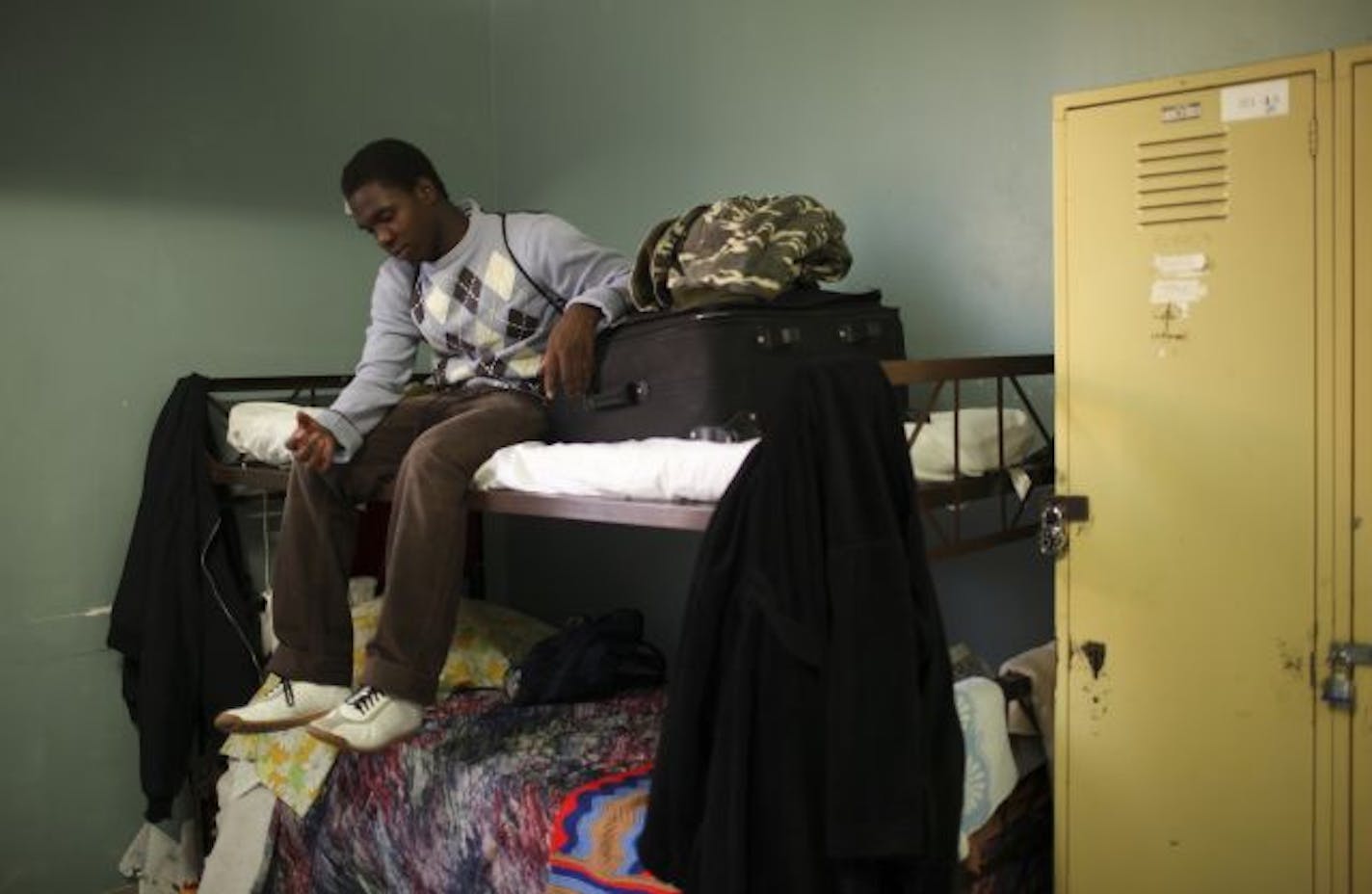 Emmett Pour sits on a bunk at the Harbor Lights shelter in downtown Minneapolis before a soccer practice. He has since found a bed in the Hope Street Shelter for young people.