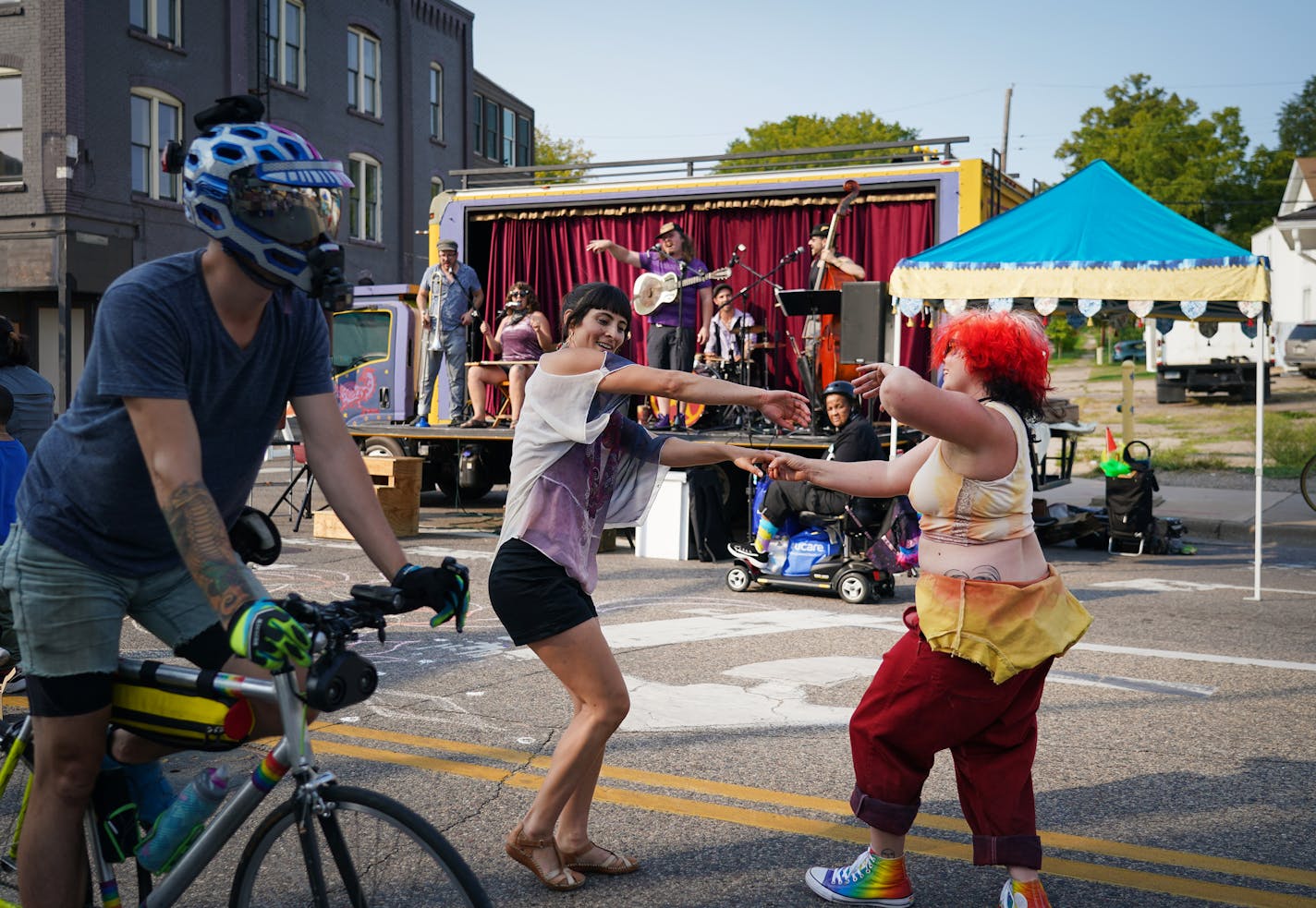 Camellia Nieh (left) and Marysia Walcerz, members of The Fox &amp; Beggar Theater, danced on the street while the group's house band played on a trailer during Open Streets West Broadway in Minneapolis on Saturday, Sept. 11, 2021.