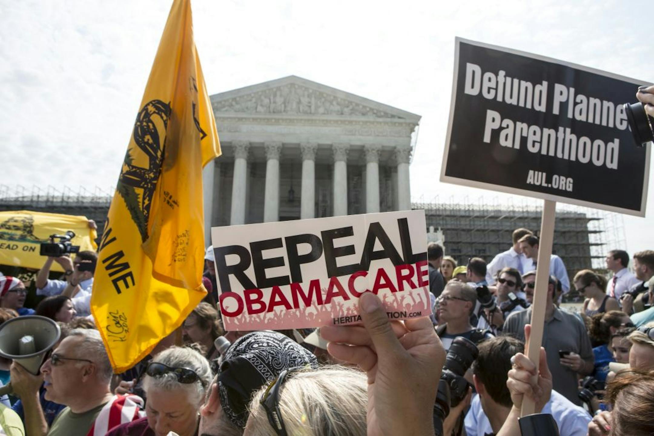 FILE -- Demonstrators protest the Affordable Care Act outside the U.S. Supreme Court in Washington, June 28, 2012. Criticism of the Supreme Court's decision to largely let President Barack Obama's health care overhaul stand has come from all sides and is directly aimed at Chief Justice John Roberts.