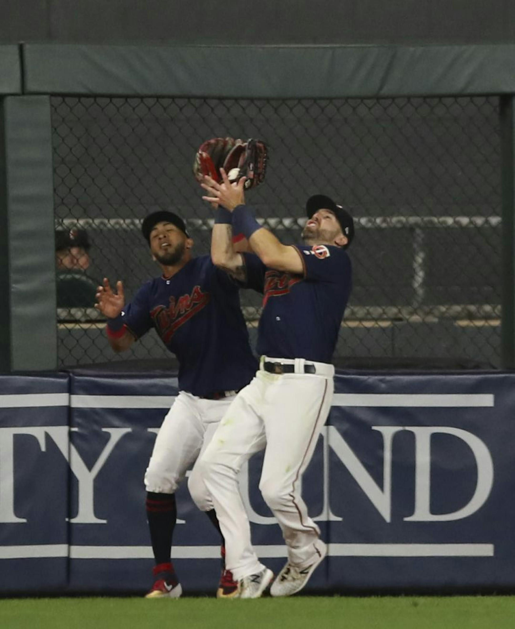 Minnesota Twins left fielder Eddie Rosario and Minnesota Twins center fielder Jake Cave, right, collided fielding a hit in the eighth by New York Yankees right fielder Aaron Judge. Cave successfully made the catch.