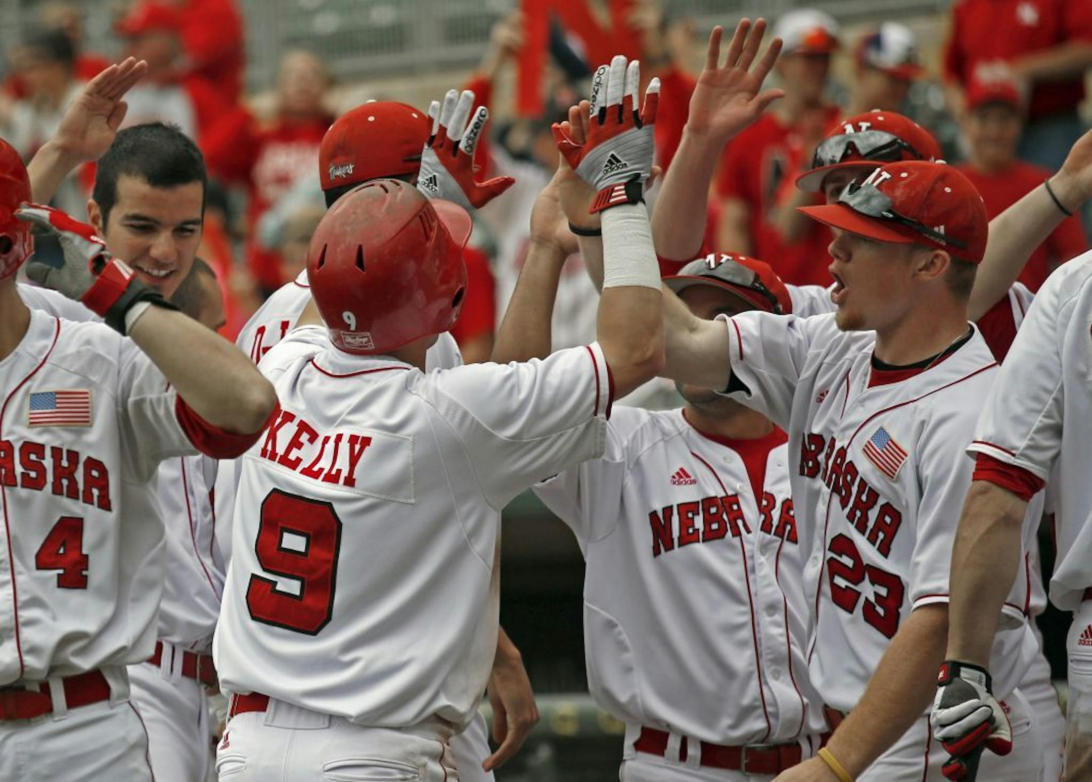 Nebraska's Pat Kelly celebrated with teammates after hitting a three run home run in the fourth inning at Target Field.