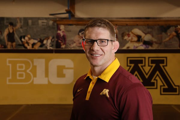 Brandon Eggum, the new wrestling coach for the University of Minnesota's Golden Gophers, stands for a portrait in the university's wrestling room Wedn