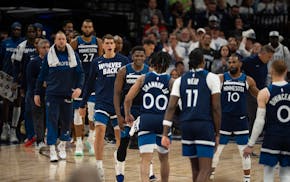 The Timberwolves' Anthony Edwards congratulates guard Terrence Shannon Jr. during at a timeout in the second quarter.