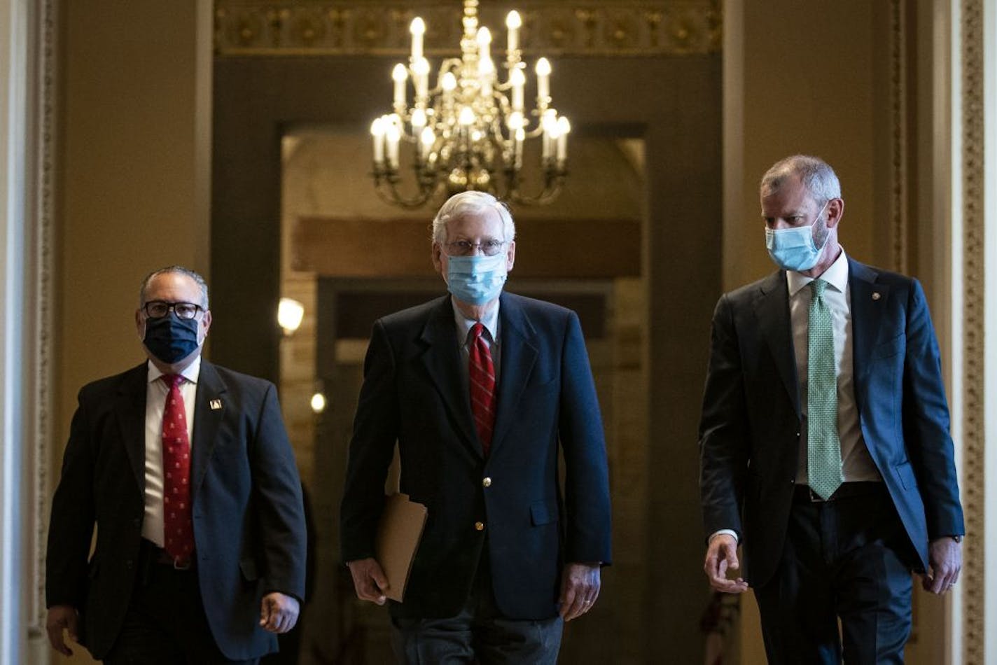 Senate Majority Leader Mitch McConnell (K-Ky.) walks to the Senate floor at the Capitol in Washington on Monday, Nov. 9, 2020. McConnell spoke from the Senate floor about vote counting in the presidential election. Declining to recognize Biden's victory, McConnell says Trump is "100 percent" entitled to challenge it.