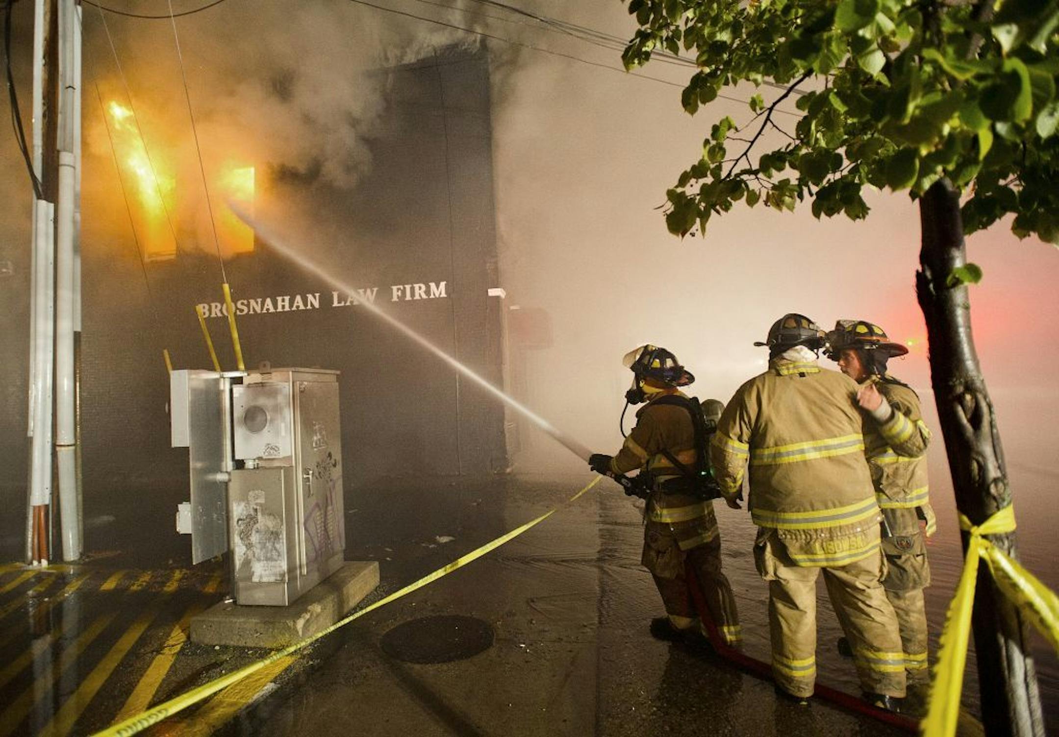 Firefighters battle a blaze in several downtown buildings early Friday, Sept. 13, 2013, in Winona, Minn.