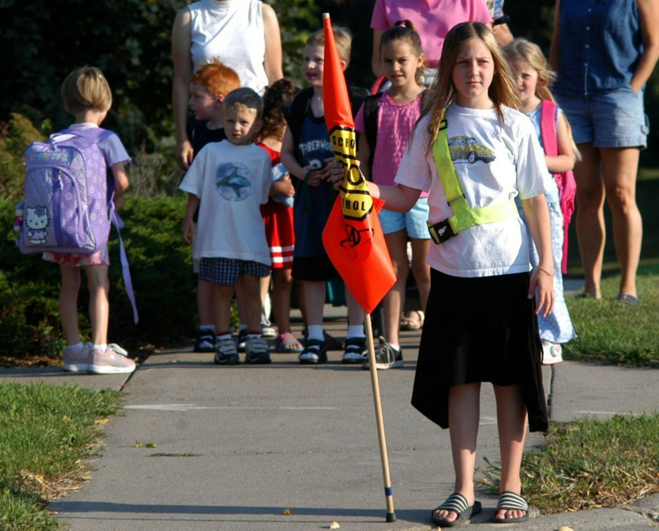 Bloomington, Mn. Friday 9/3/2004 Richard Sennott/ Star Tribune tens of thousands of students returned to school this week and their safety is in the hands of kids no older than they are: the ubiquitous school patrol. one of the best school patrols in the state is located in bloomington at ridgeview elementary. Taylor Weniger 10 yrs old has been a crossing guard for 2 yrs now . She helped these children cross to the Ridgeview Elementary School in the morning before school. GENERAL INFORMATION: Bl