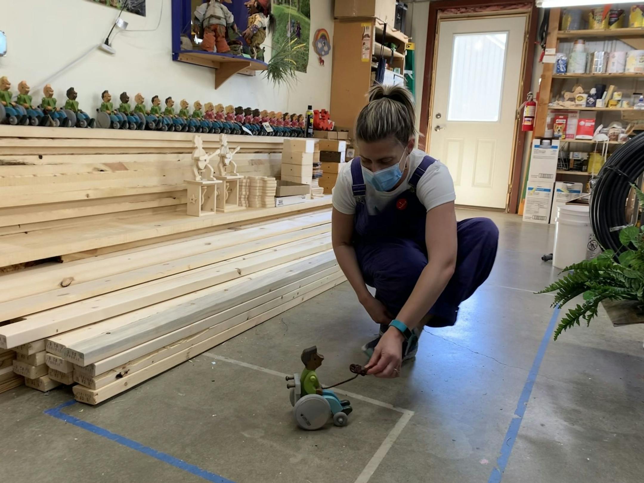 Miranda Gray-Burlingame test-drives one of the newest handmade wooden toys at LARK Toys in Kellogg, Minn. Her family-owned shop is one of many Minnesota businesses dealing with customers who threaten and bluster when asked to put on a mask for the safety of all. Star Tribune photo/Jennifer Brooks