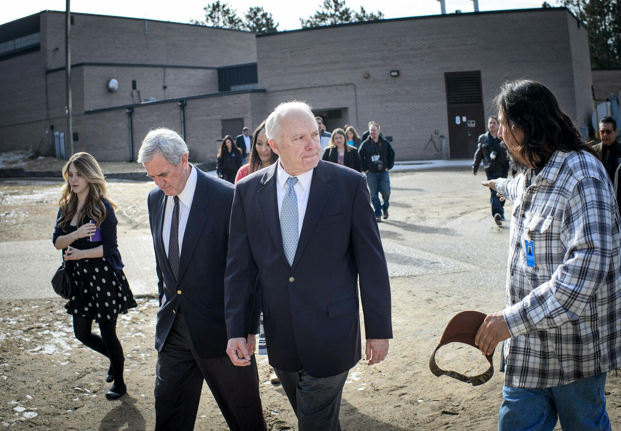 School custodian Ben Bowstring, left, walked Rep. Rick Nolan and Rep. John Kline through an area from one school building to a trailer used as a classroom that student have to travel throughout the day even in below zero temperatures.