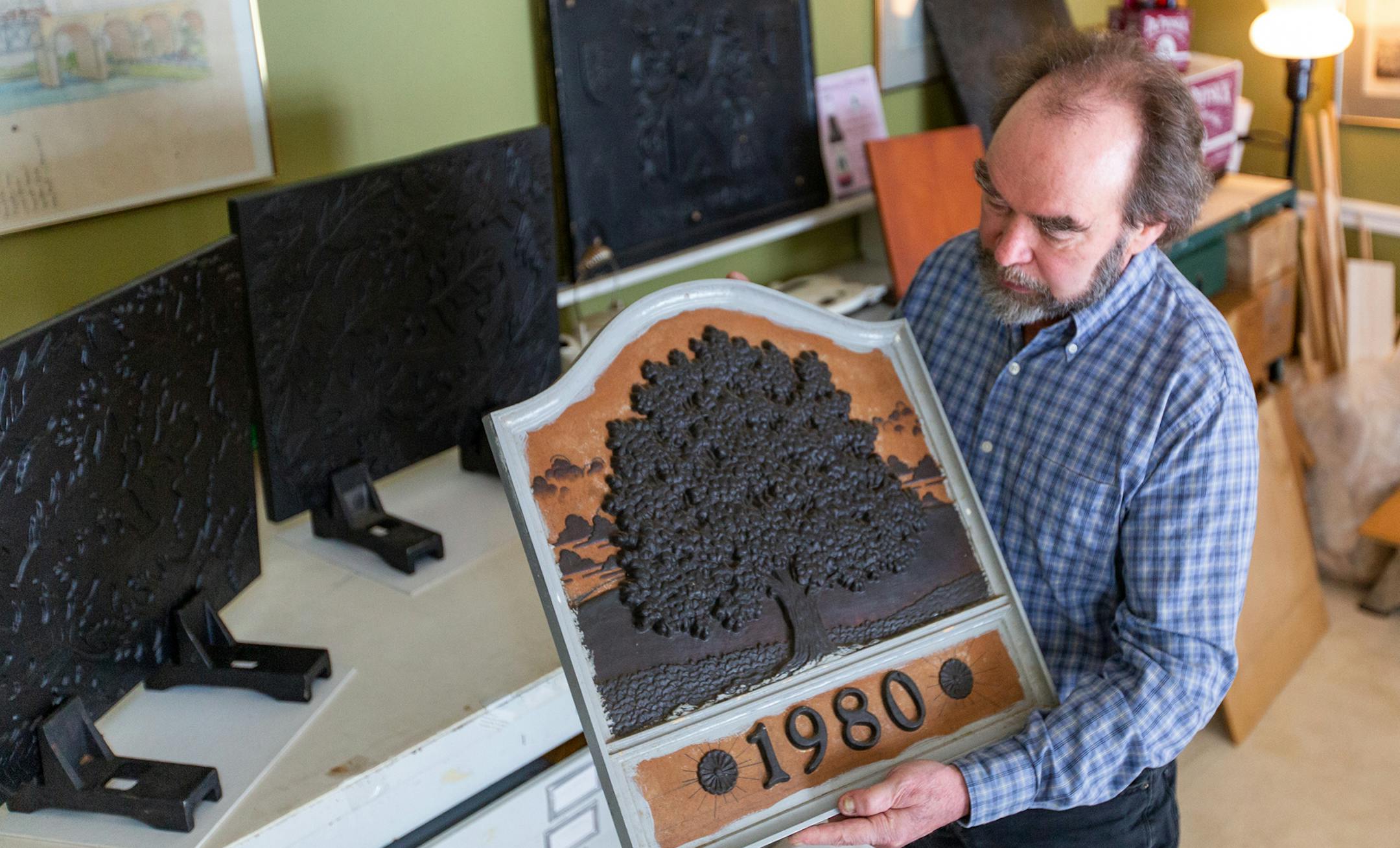 J. Del Conner holds a mold of his most popular fireback design, "The Great Oak", at his home, which doubles as a studio, in Hamburg, Pa., on February 21, 2019. Conner, who owns Pennsylvania Firebacks, makes original firebacks, decorative pieces for fireplaces, and claims they are being pirated in China. (Margo Reed/Philadelphia Inquirer/TNS) ORG XMIT: 1282820