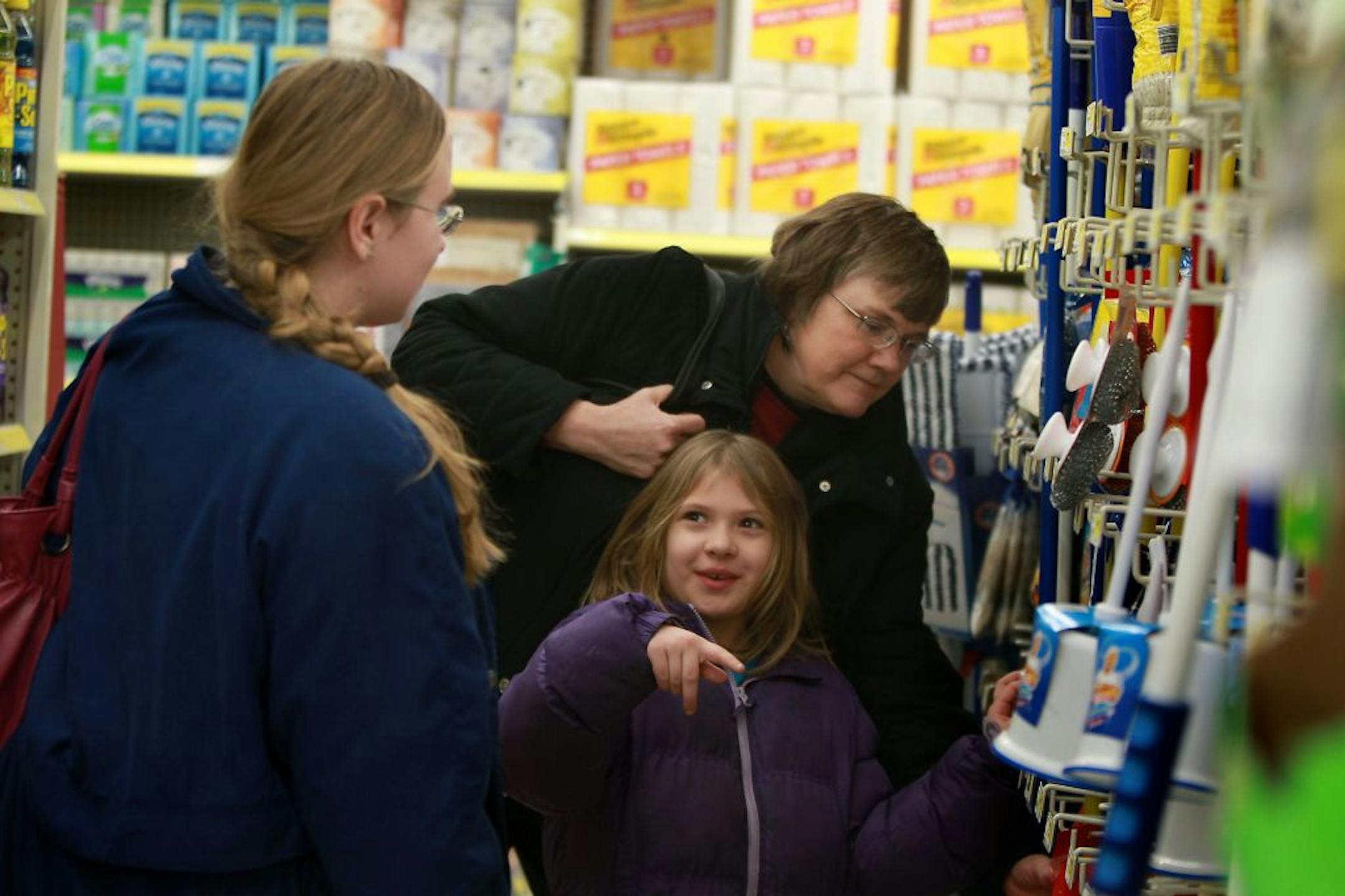 Summer Martin, 7, center joined her mother Heather Moseng, left, and grandmother Roxie Laugeson on a shopping trip to Dollar General in Mounds View, MN, Monday, January 16, 2012. Dollar General is expanding nationwide this year, adding another 625 stores.