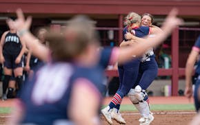 United South Central pitcher Mariah Anderson, left, hugs catcher Taylor Schroeder after USC defeated Badger/Greenbush-Middle River 2-0 for the Class 1