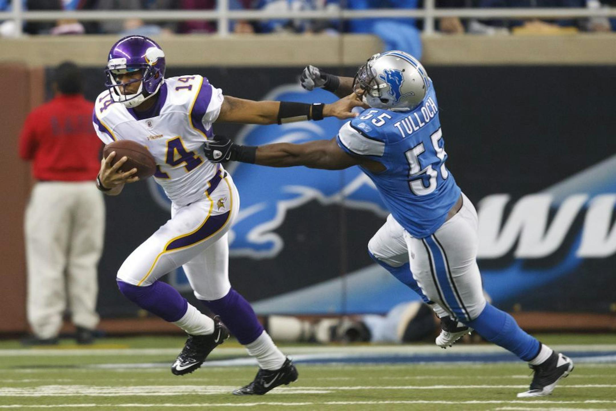 Minnesota Vikings quarterback Joe Webb (14) stiff arms Detroit Lions middle linebacker Stephen Tulloch (55) in the third quarter of an NFL football game in Detroit, Sunday, Dec. 11, 2011.