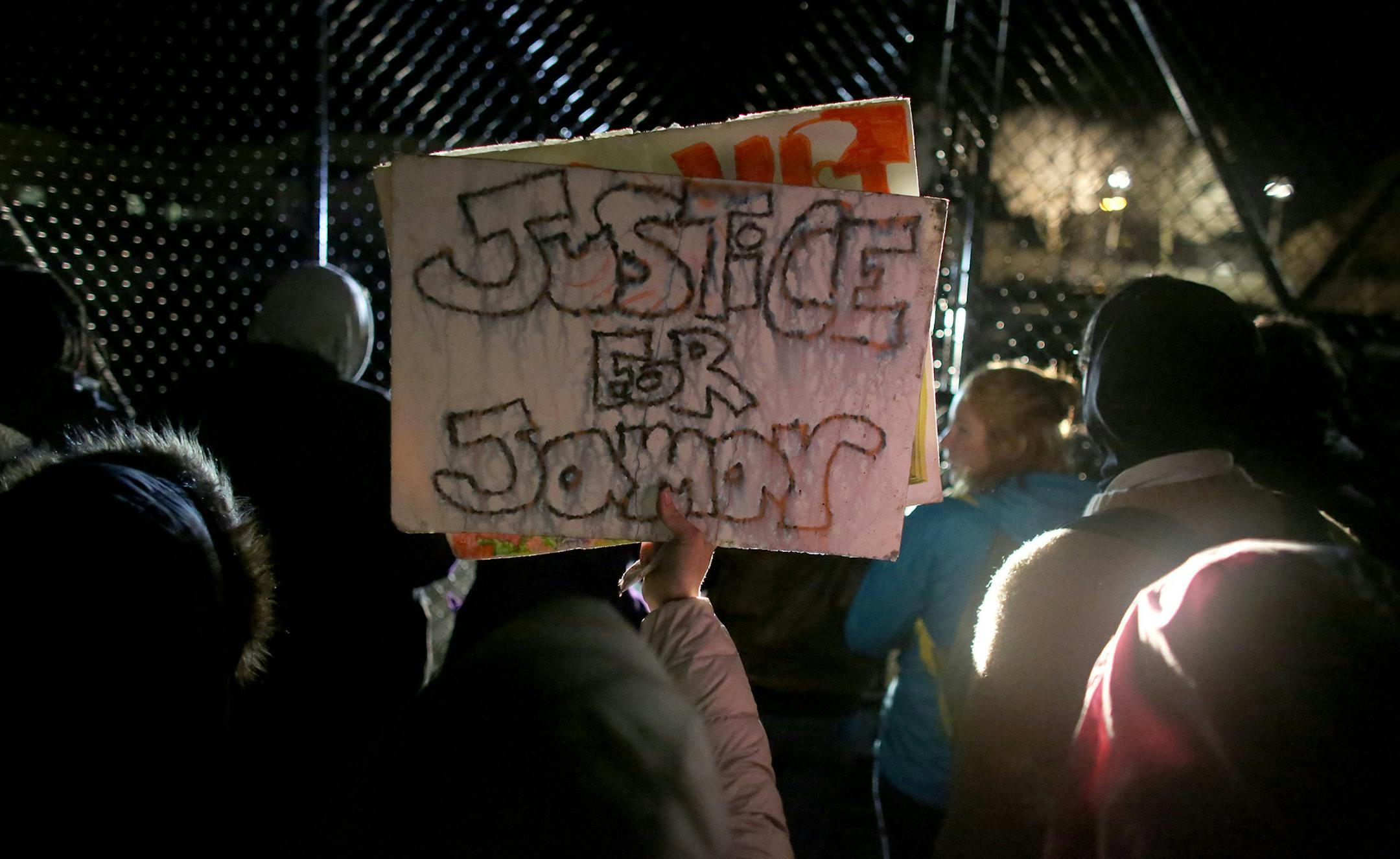 Protesters moved to the gated parking lot of the Minneapolis Fourth Precinct to chant during their outside occupation outside surrounding area. ] (KYNDELL HARKNESS/STAR TRIBUNE) kyndell.harkness@startribune.com Black Lives Matter protested in front of Minneapolis Fourth Precinct in Minneapolis Min., Wednesday November 18, 2015. ORG XMIT: MIN1511182040590683