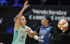 Minnesota Lynx guard Odyssey Sims, right, looks to pass with New York Liberty guard Bria Hartley defending during the first half of a WNBA basketball 