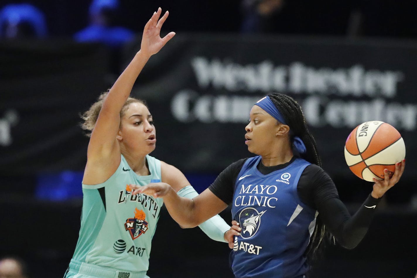 Minnesota Lynx guard Odyssey Sims, right, looks to pass with New York Liberty guard Bria Hartley defending during the first half of a WNBA basketball game Tuesday, Aug. 13, 2019, in White Plains, N.Y. (AP Photo/Kathy Willens)