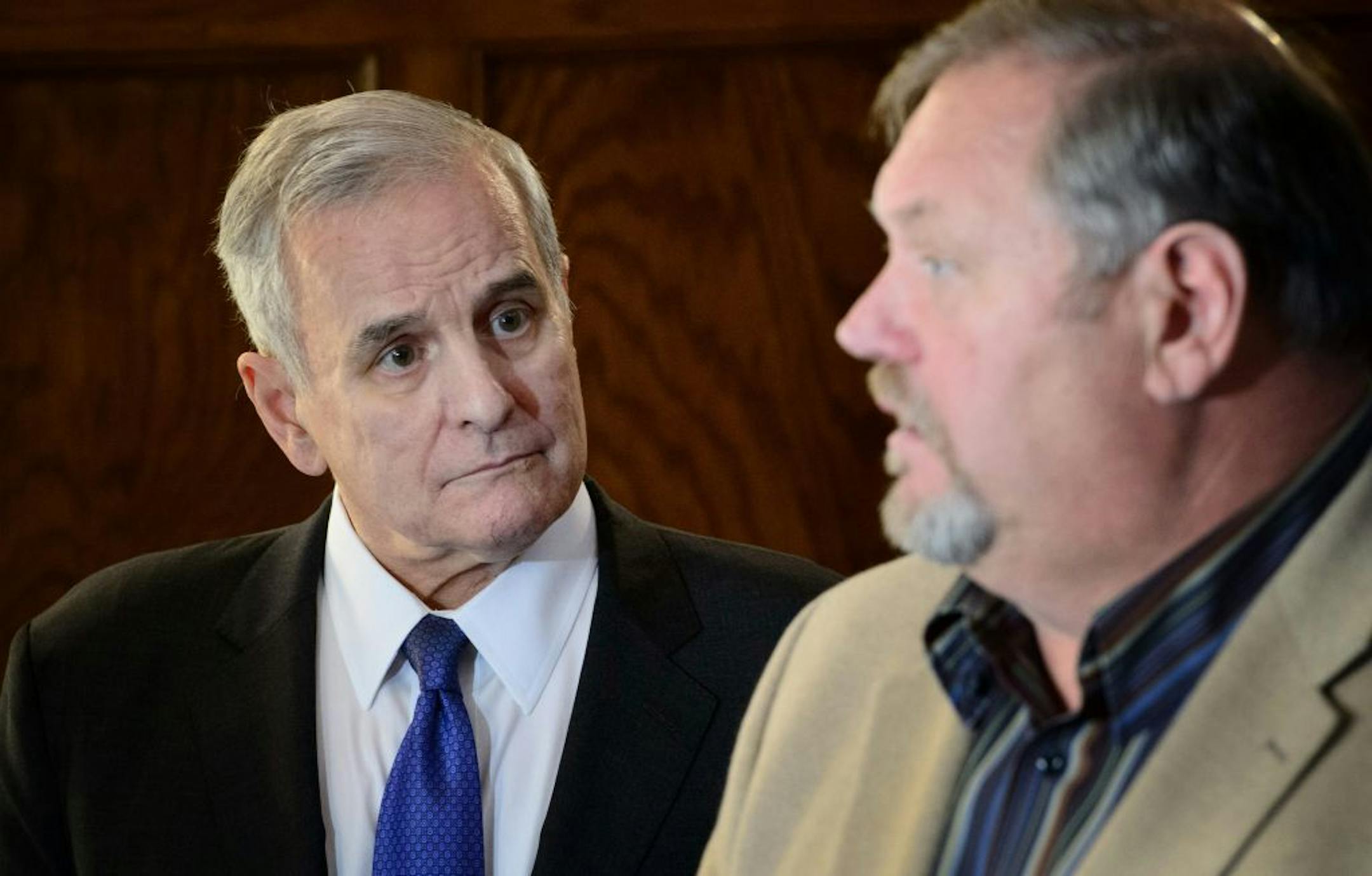 Governor Mark Dayton listened as Majority Leader Tom Bakk talked to the media after the special session meeting at the Governor's residence.