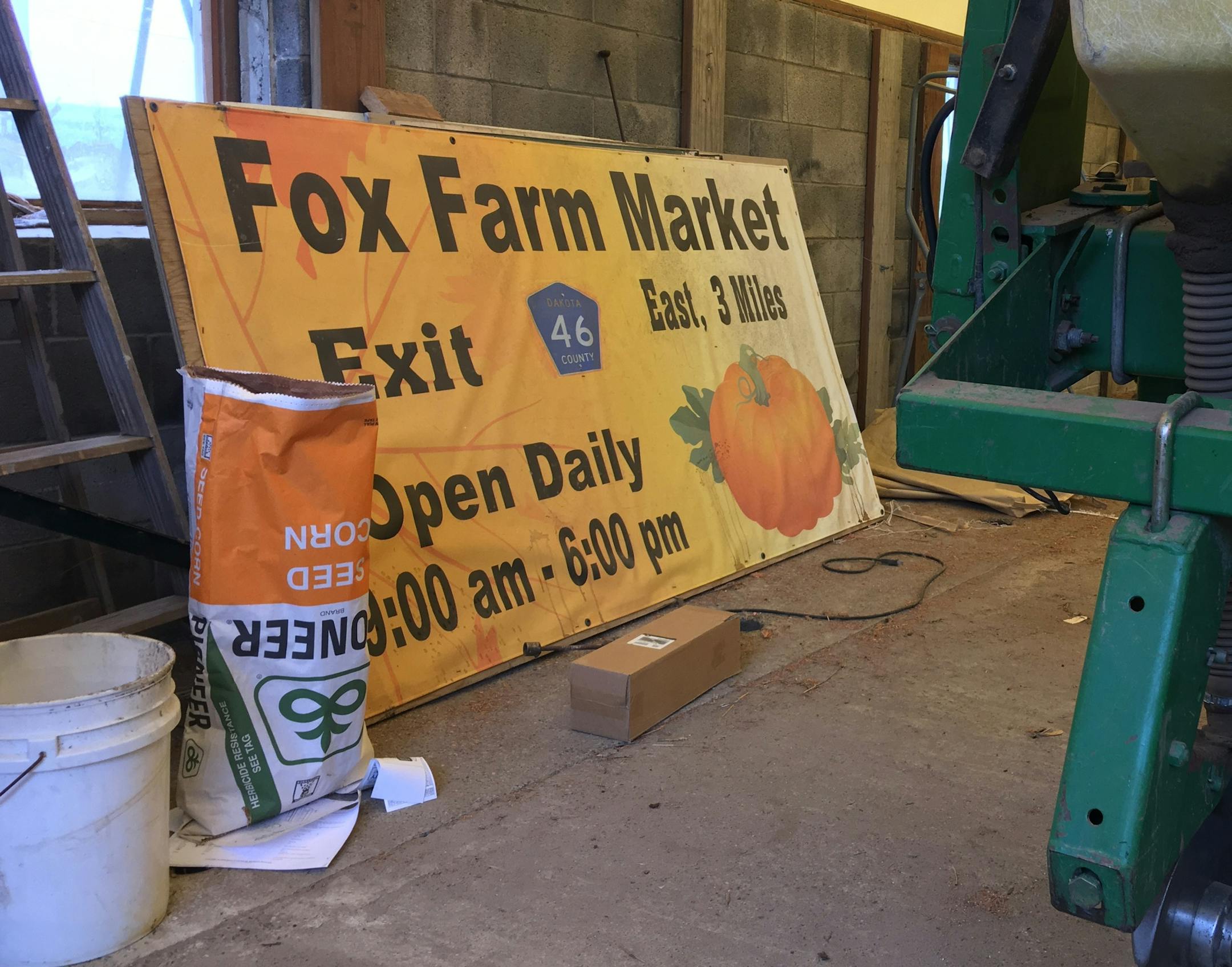 By Erin Adler. A sign advertising the family's store sits next to a corn planter.