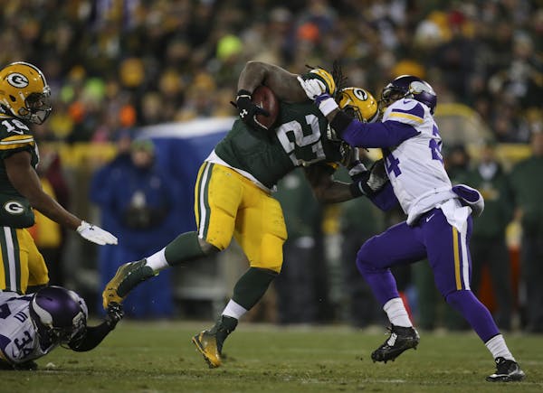 Vikings strong safety Andrew Sendejo (34) and cornerback Captain Munnerlyn (24) tried to stop Packers running back Eddie Lacy last season.