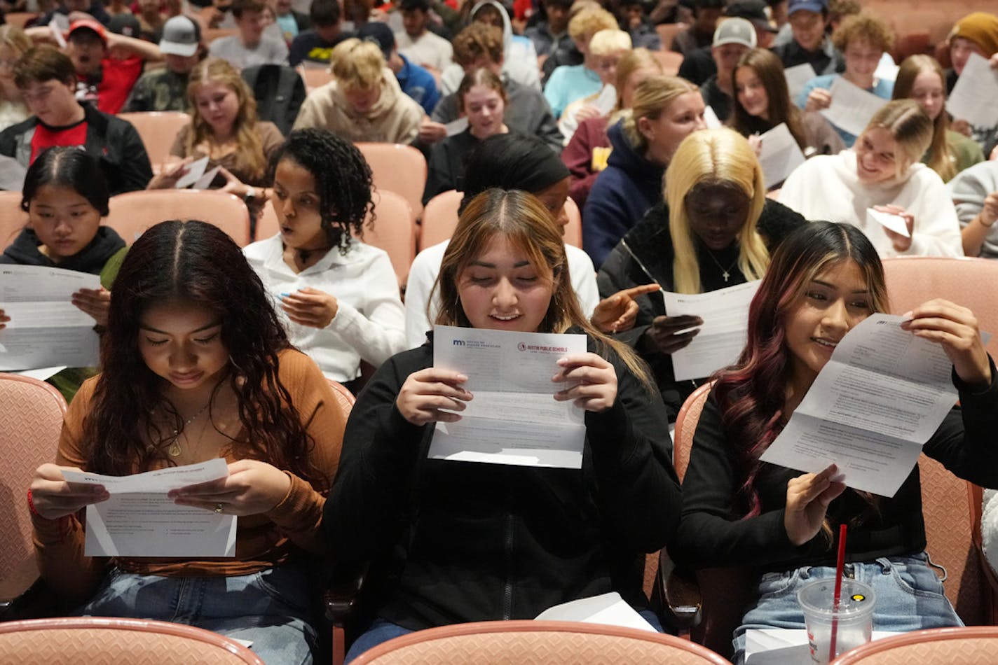 Students, from left, Araiza Maldonado Basilio, Alexa Velasquez Mendoza, and Leslie Sandoval Reyes, open letters informing them what Minnesota colleges and universities they've been pre-accepted to as part of the state's Direct Admissions program Wednesday, Oct. 28, 2023 at Austin High School in Austin, Minn. ] ANTHONY SOUFFLE • anthony.souffle@startribune.com