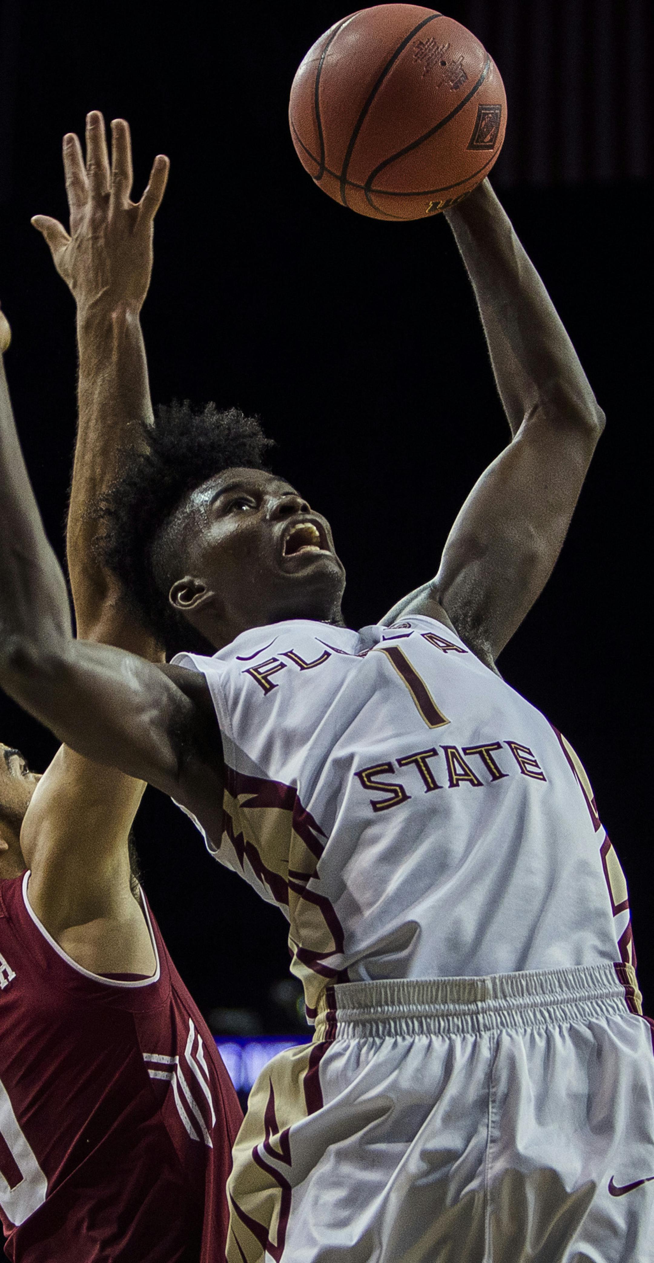 Florida State's Jonathan Isaac (1) misses his shot covered by Temple's Obi Enechionyia (0) during an NCAA college basketball game in the semifinals of the NIT Season Tip-Off tournament in New York, Thursday, Nov. 24, 2016. (AP Photo/Andres Kudacki)