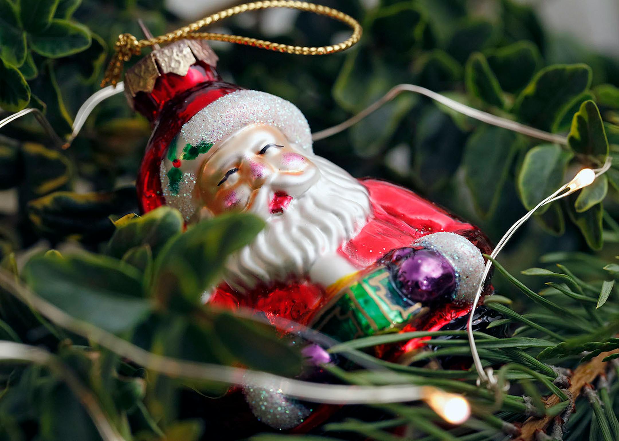 Pick out several ornaments with a common element such as shiny glass, to tuck into greens across a fireplace mantel.
