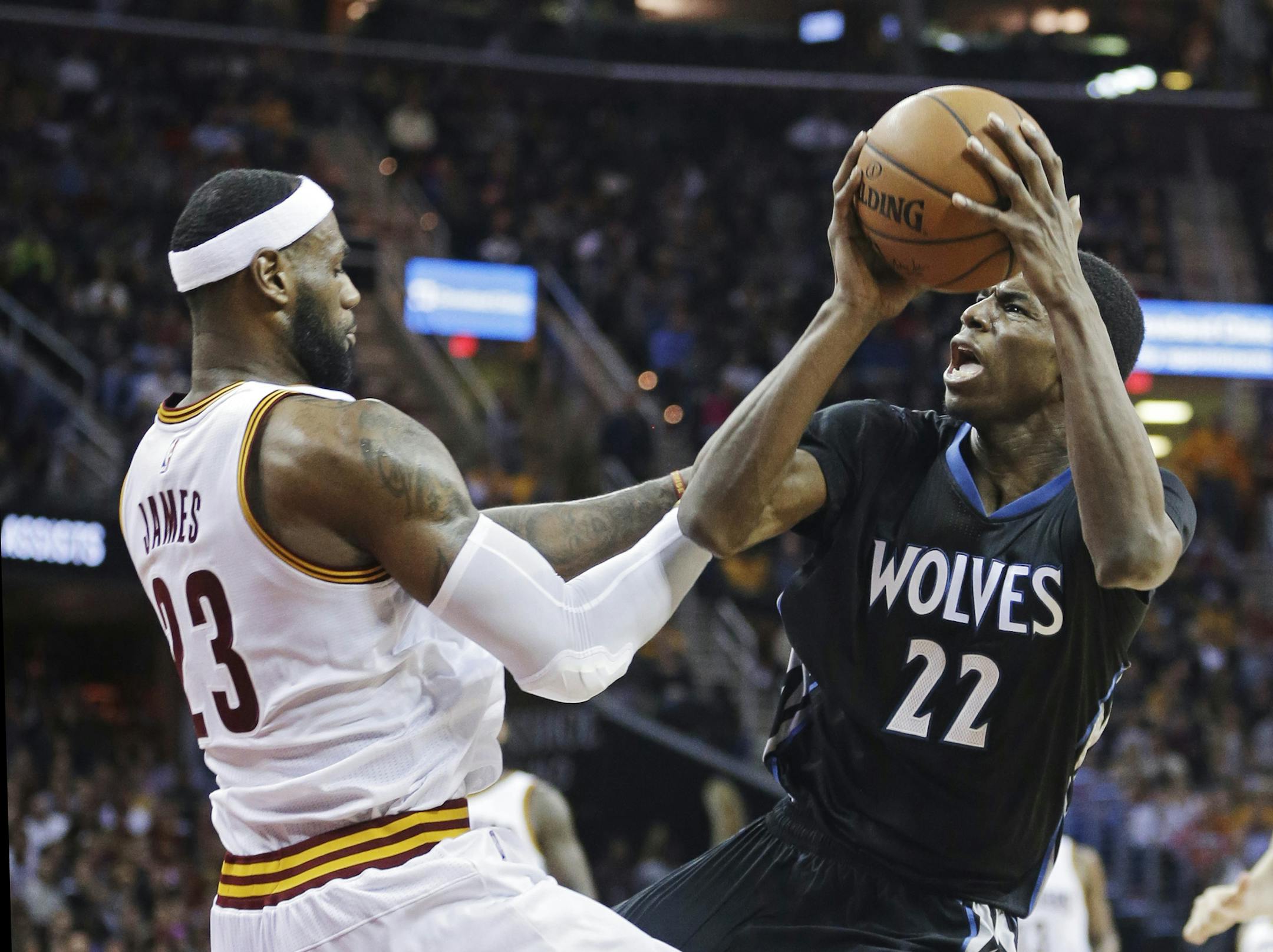 Minnesota Timberwolves' Andrew Wiggins (22) is fouled by Cleveland Timberwolves rookie Andrew Wiggins, battling Cavaliers LeBron James on Tuesday, said guarding Kobe Bryant is tougher than guarding James.