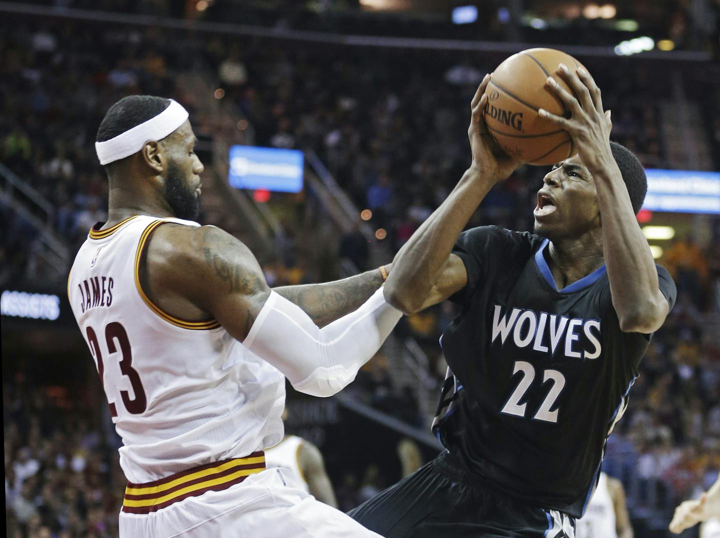 Minnesota Timberwolves' Andrew Wiggins (22) is fouled by Cleveland Timberwolves rookie Andrew Wiggins, battling Cavaliers LeBron James on Tuesday, said guarding Kobe Bryant is tougher than guarding James.